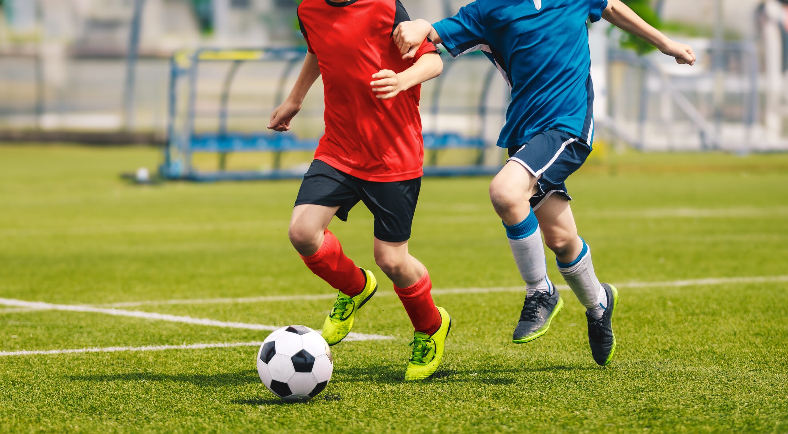 Two,Soccer,Players,Chase,A,Soccer,Ball,In,A,Duel.