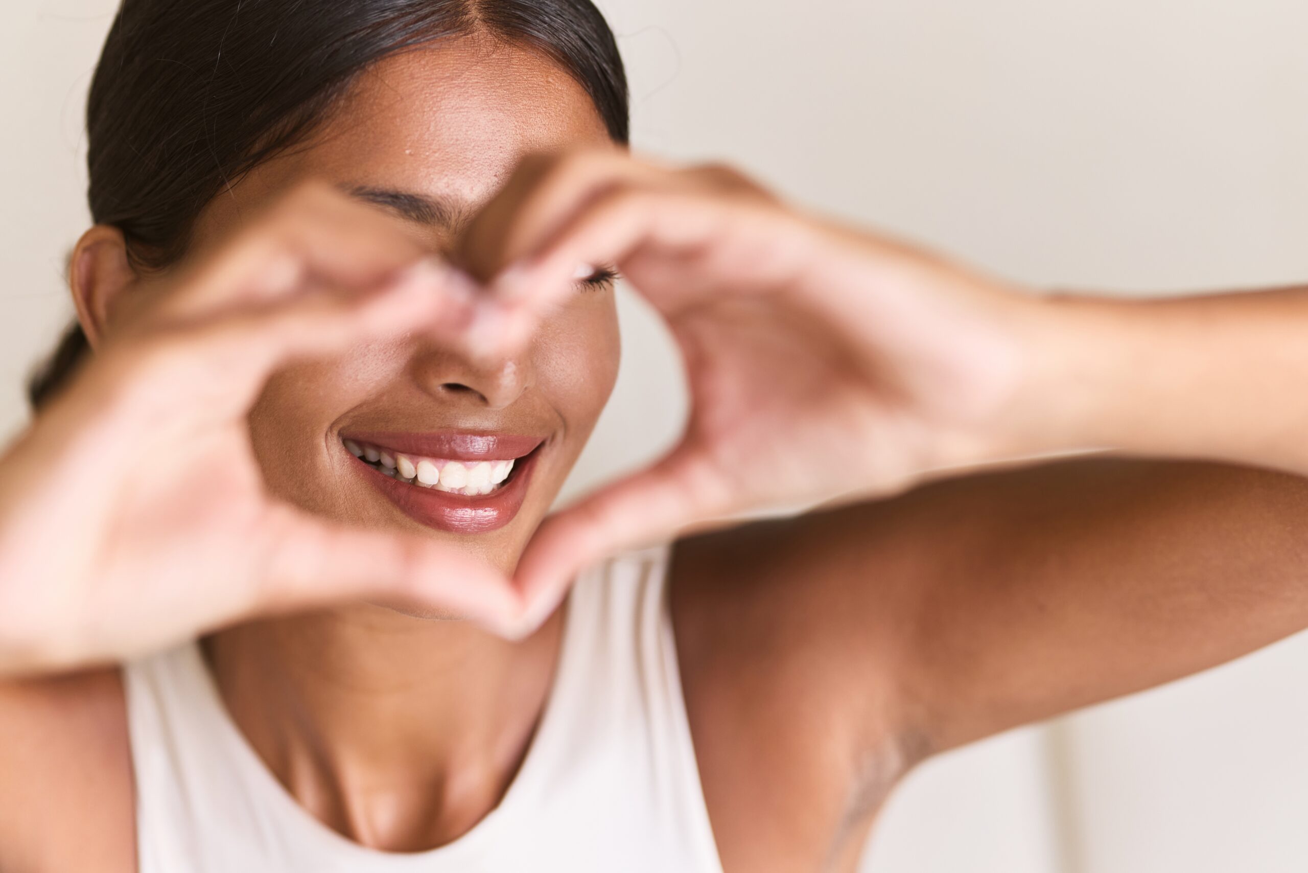 Teeth,Whitening.,Woman,Creating,Heart,Shape,With,Hands,,Radiating,Happiness
