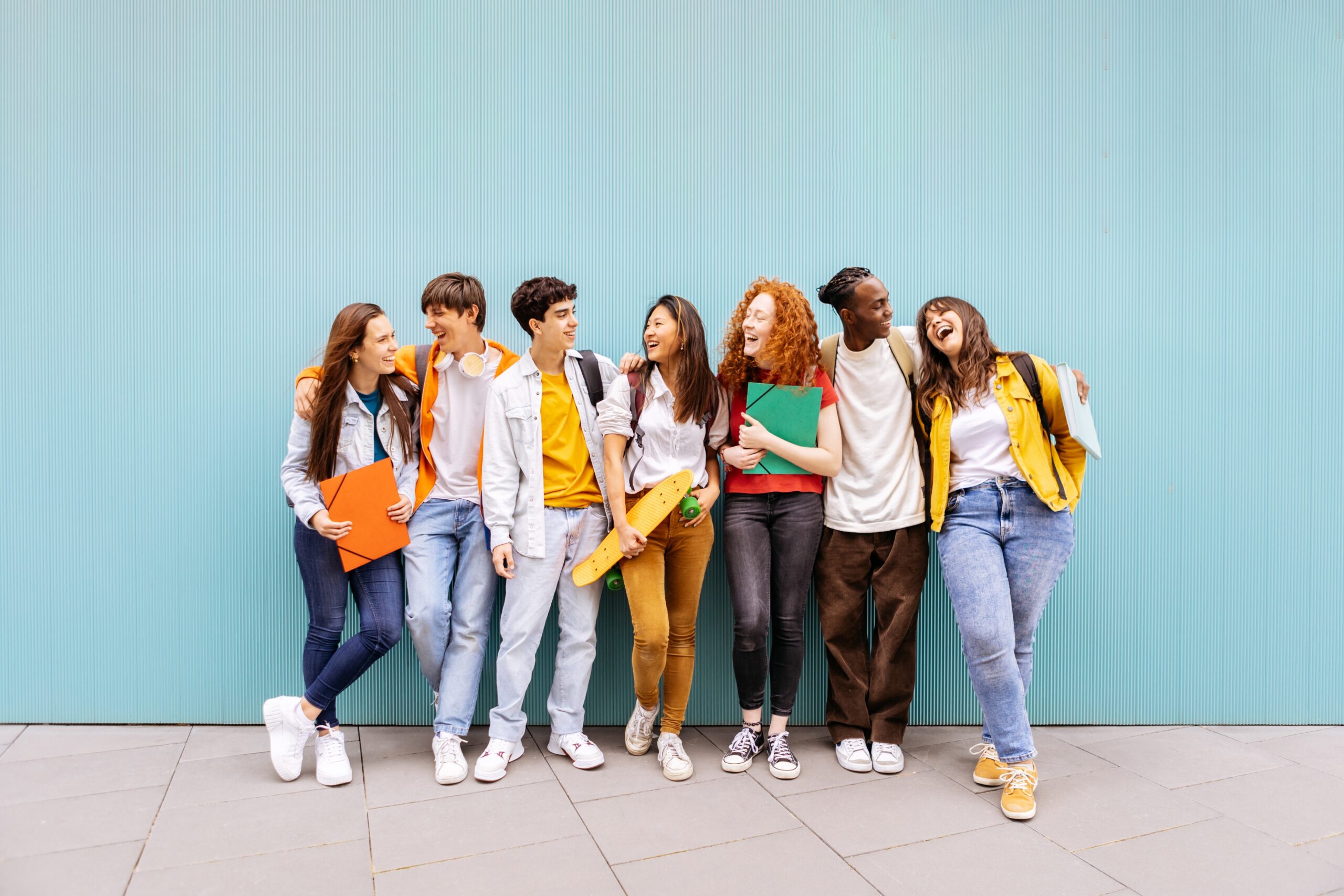Happy,Multiracial,Students,Standing,Over,Isolated,Blue,Background.,Diverse,Teenage